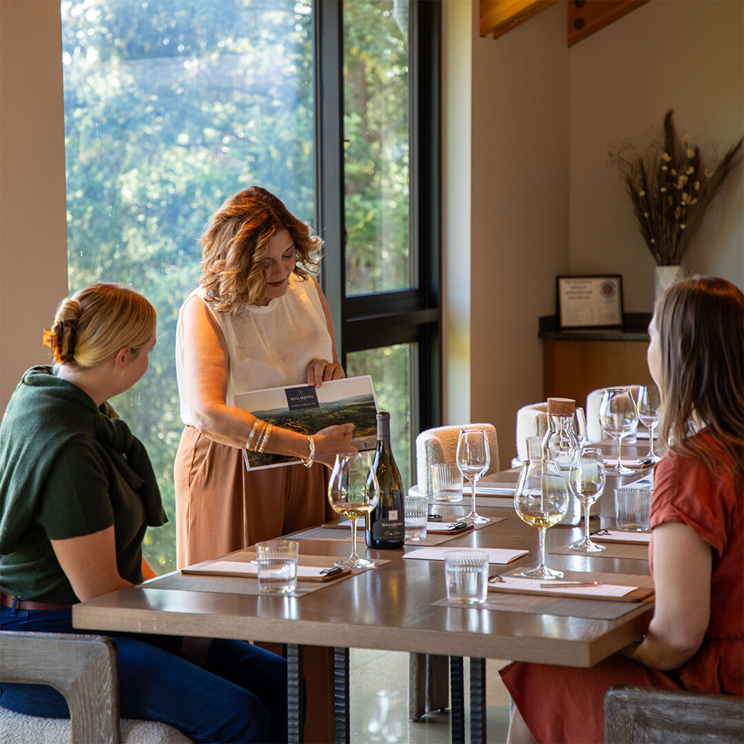 WillKenzie Estate hospitality team member pouring pinot noir in Tasting Room